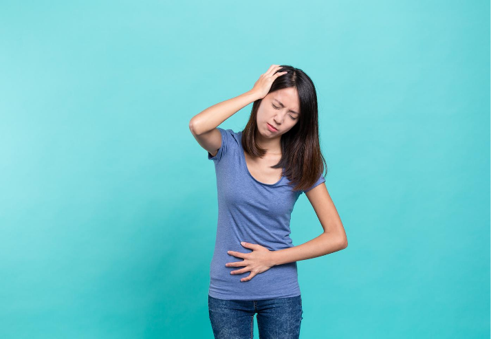 Woman in Blue with Digestive Discomfort