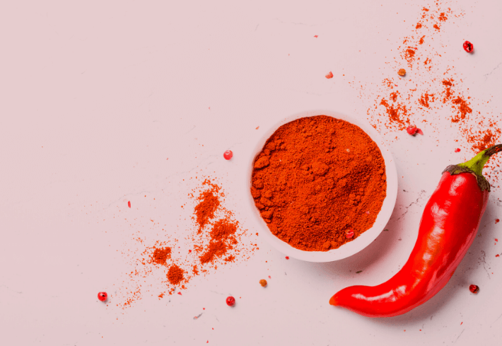 Cayenne Pepper Ground and Fresh on Pink Background