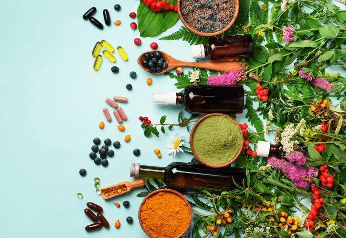 Ingredients and Capsules on Blue Background