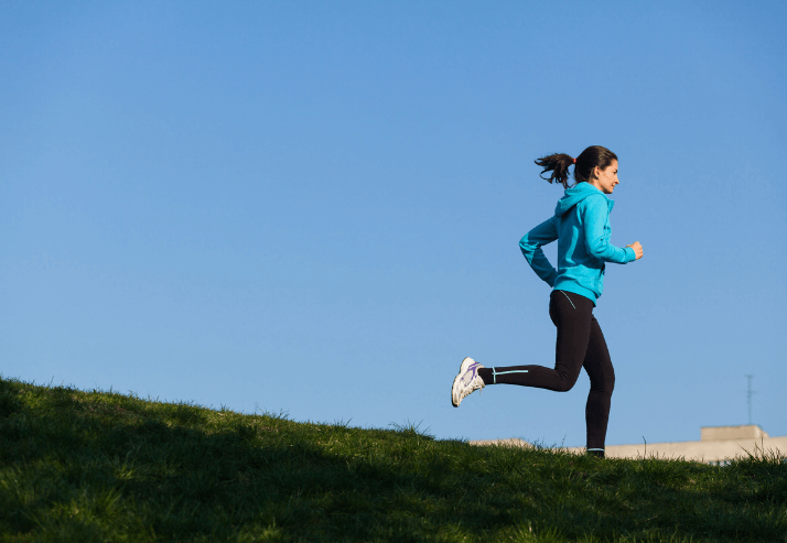 Woman Running on Hill