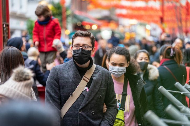 People walking in streets  wearing  masks