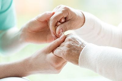 Young hands holding elderly hands
